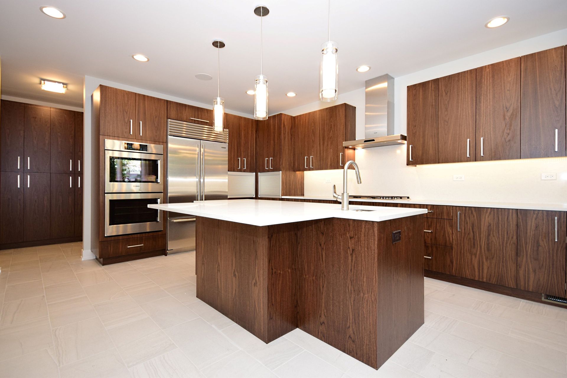 A kitchen with stainless steel appliances and wooden cabinets