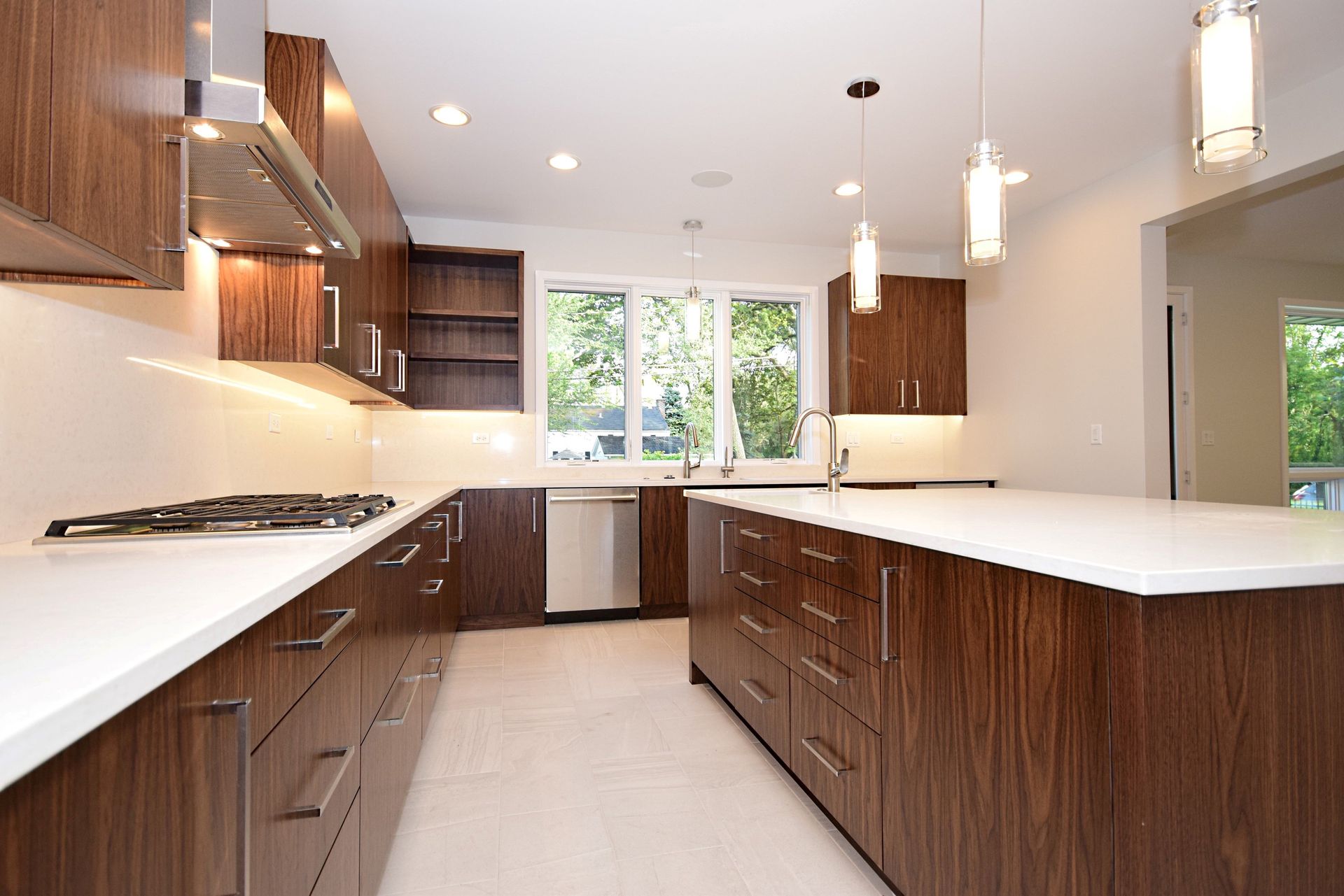 A kitchen with wooden cabinets and white counter tops