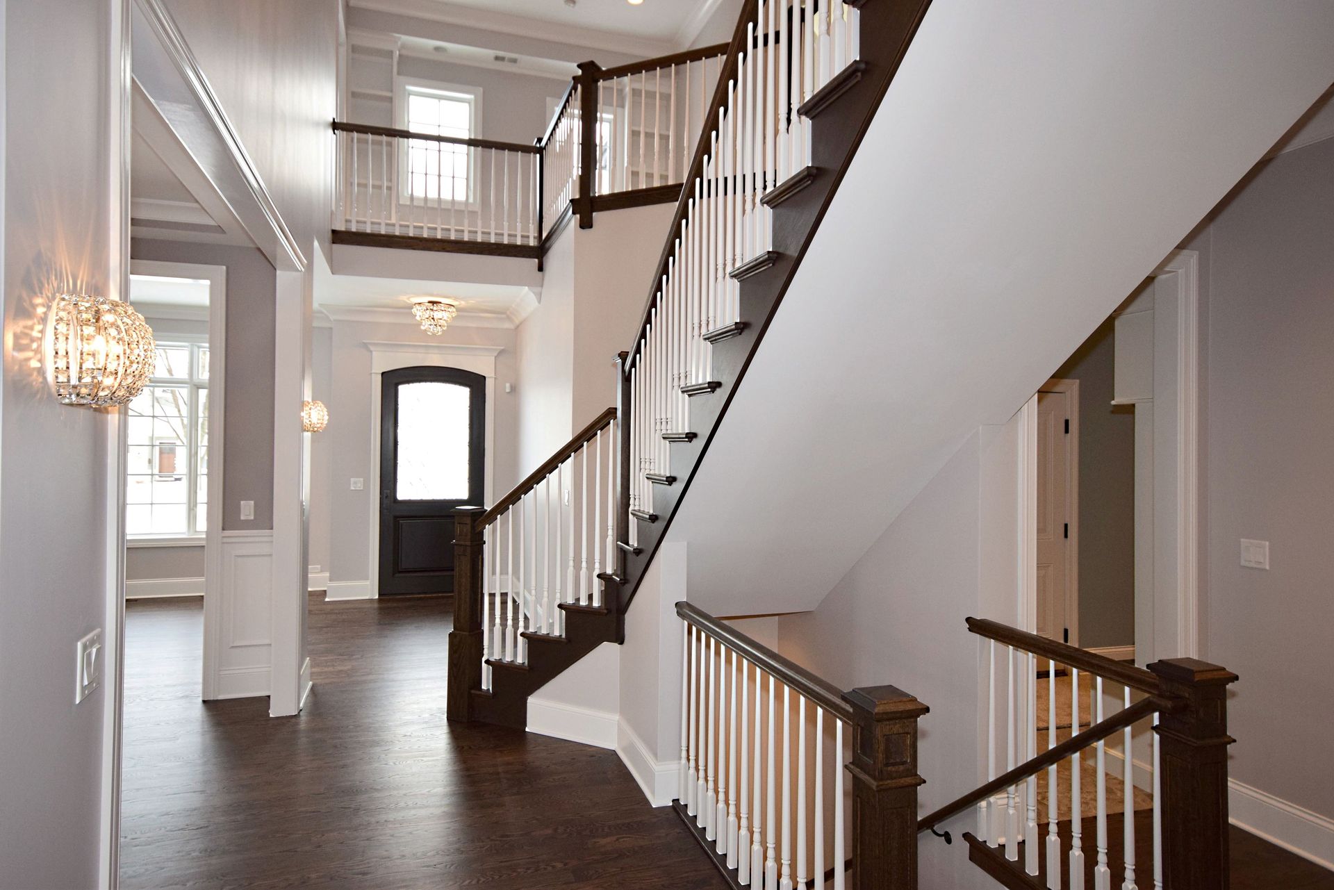 A large hallway with a staircase leading up to the second floor