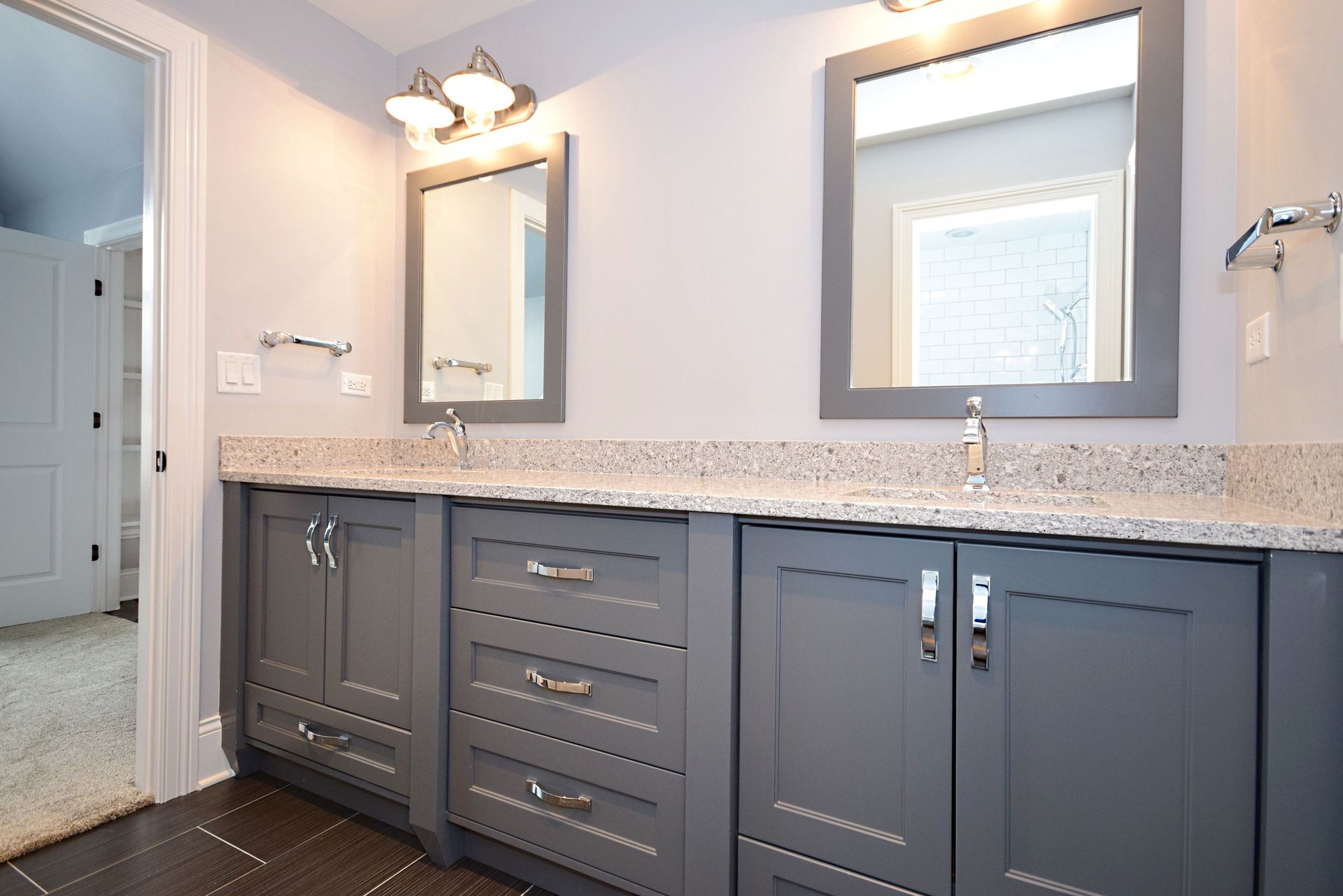 A bathroom with two sinks and two mirrors.