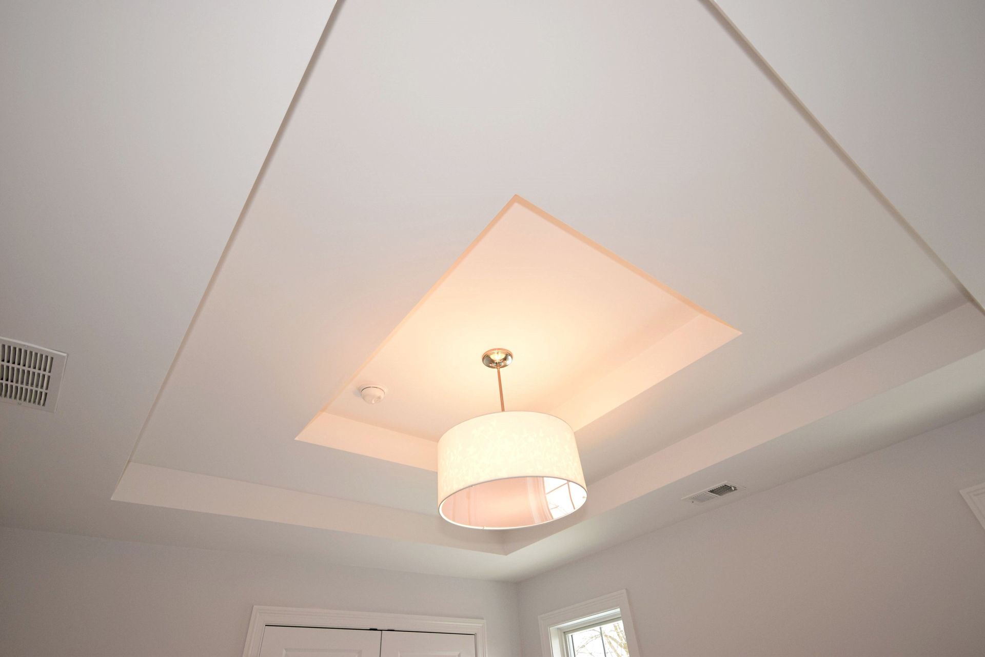 A light fixture is hanging from the ceiling of a room.