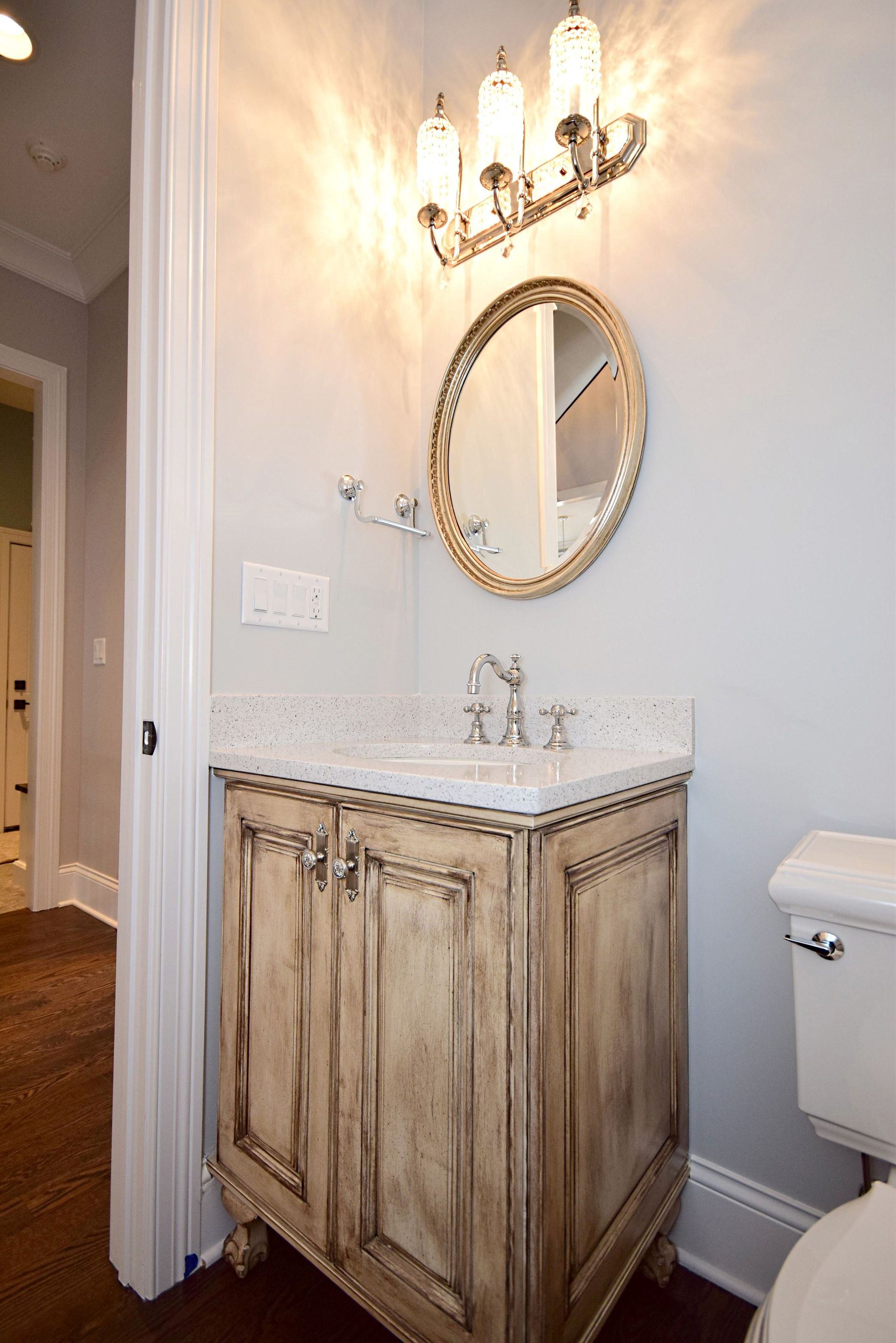 A bathroom with a sink , mirror and toilet.