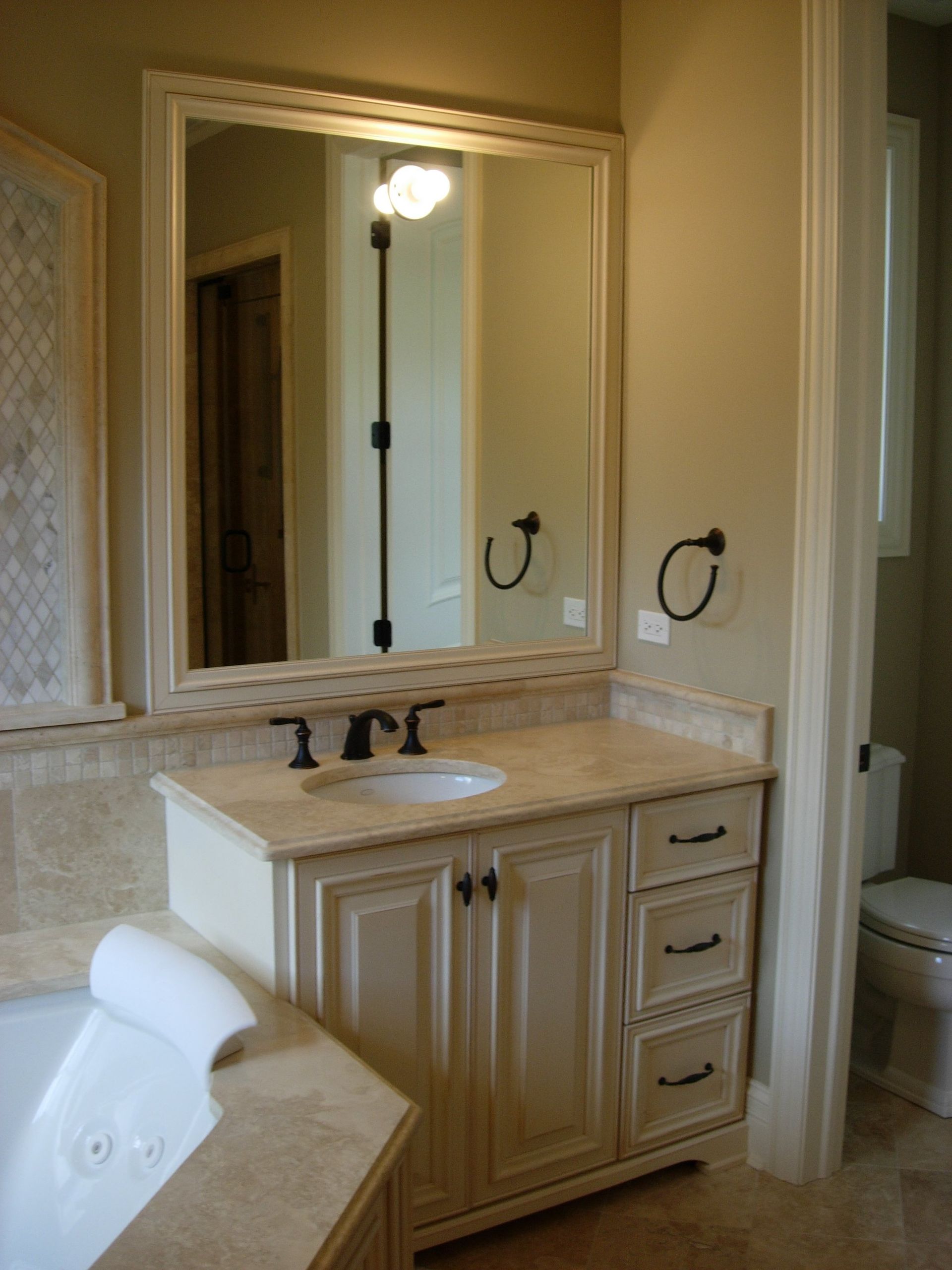 A bathroom with a sink a mirror and a toilet