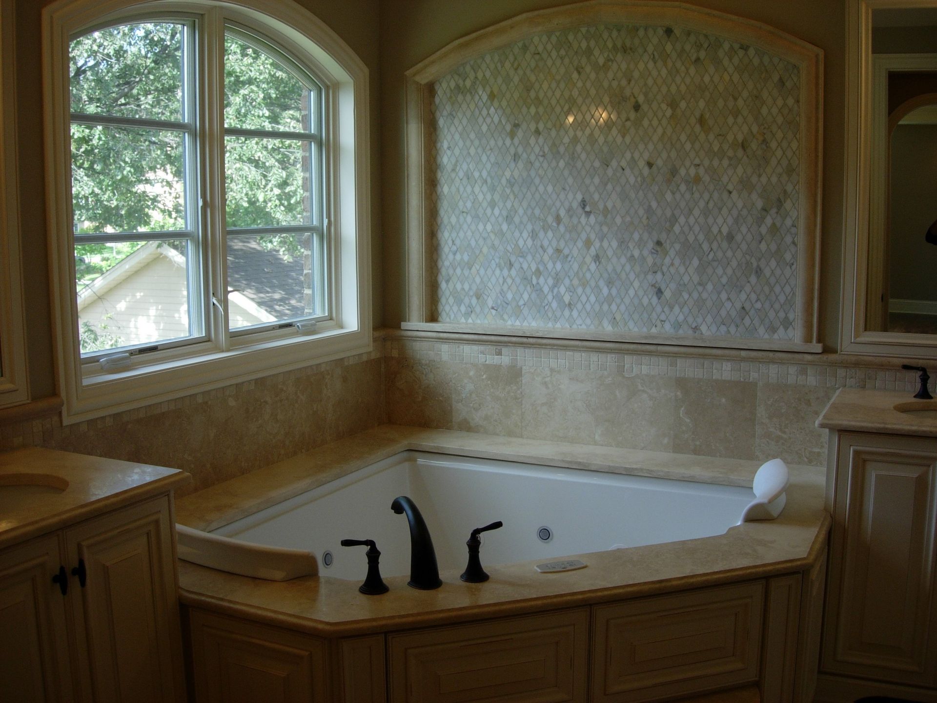 A bathroom with a jacuzzi tub and a window