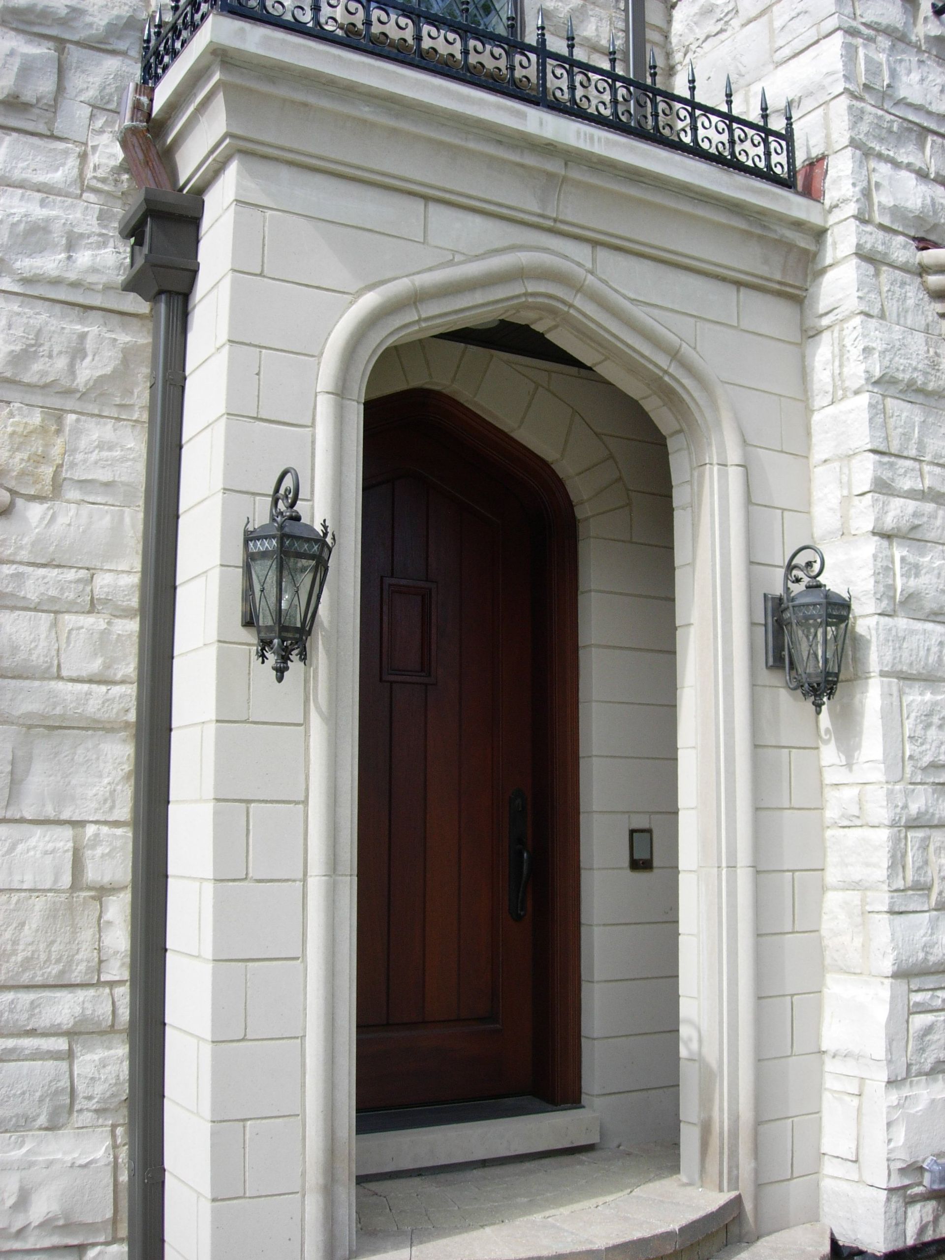 A white brick building with a wooden door