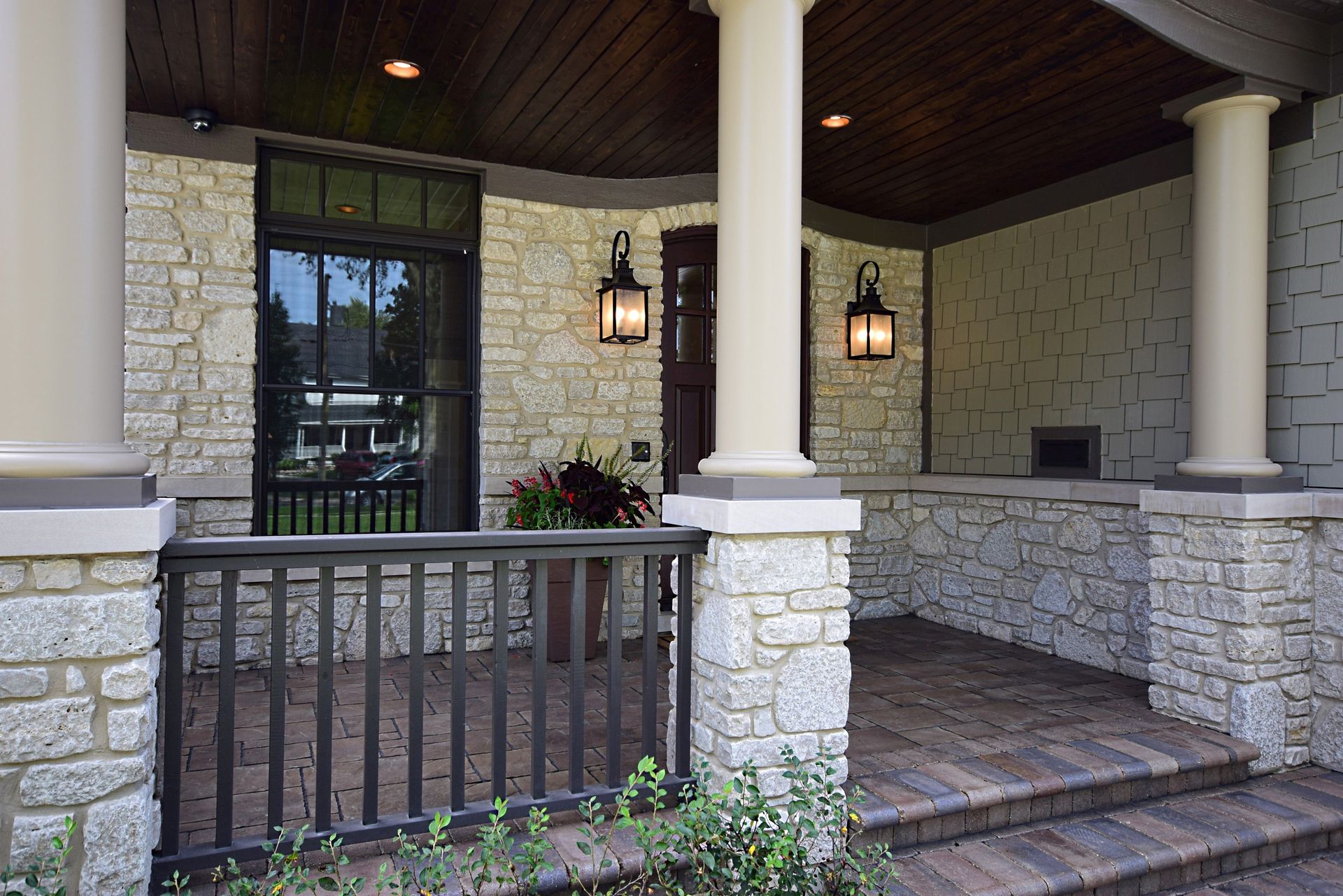 There is a porch with a railing and stairs leading up to it.