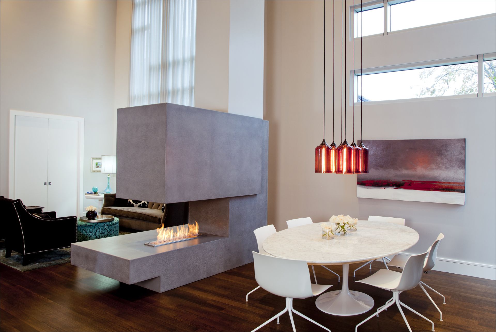 A living room with a fireplace and a dining table