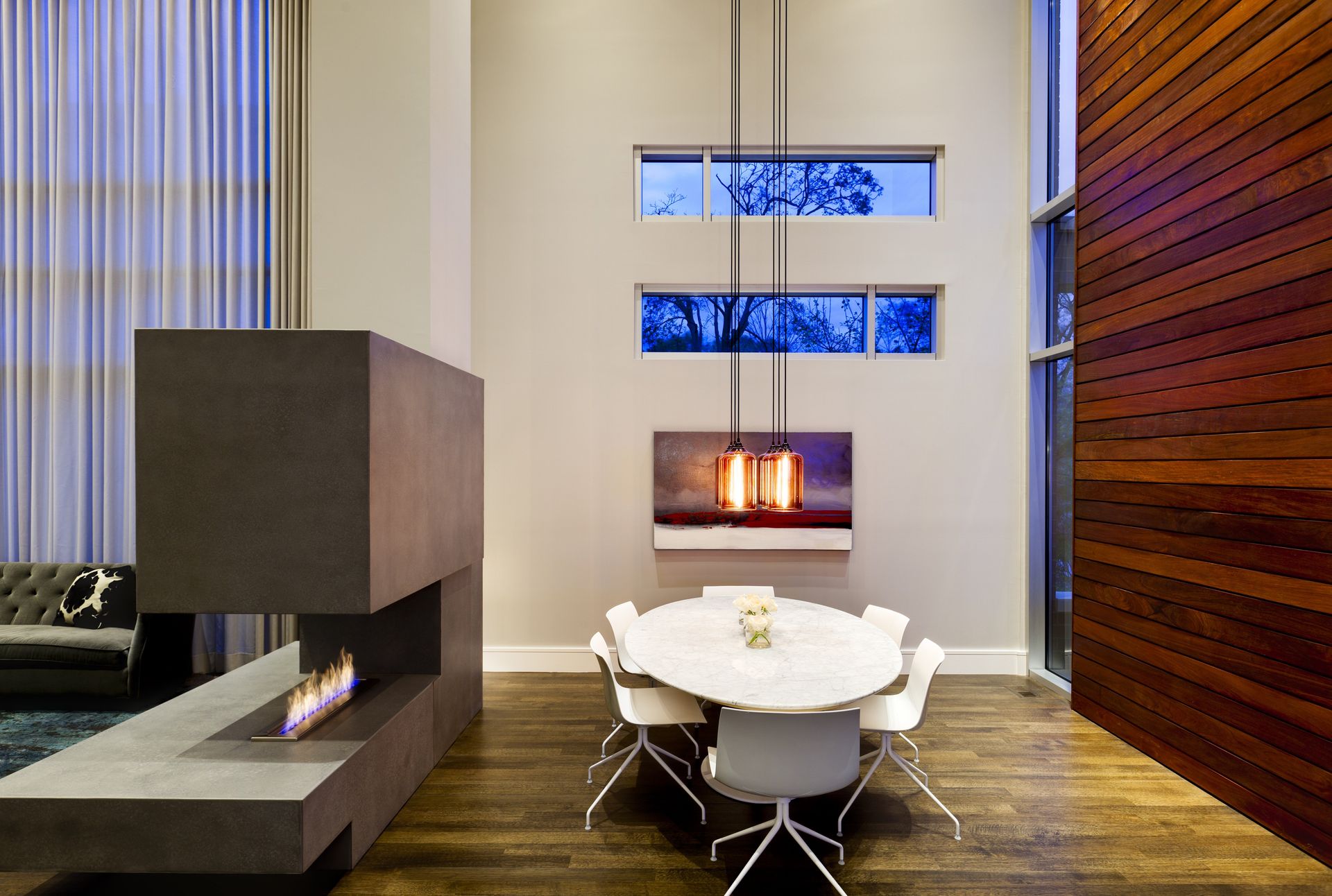 A dining room with a table and chairs and a fireplace