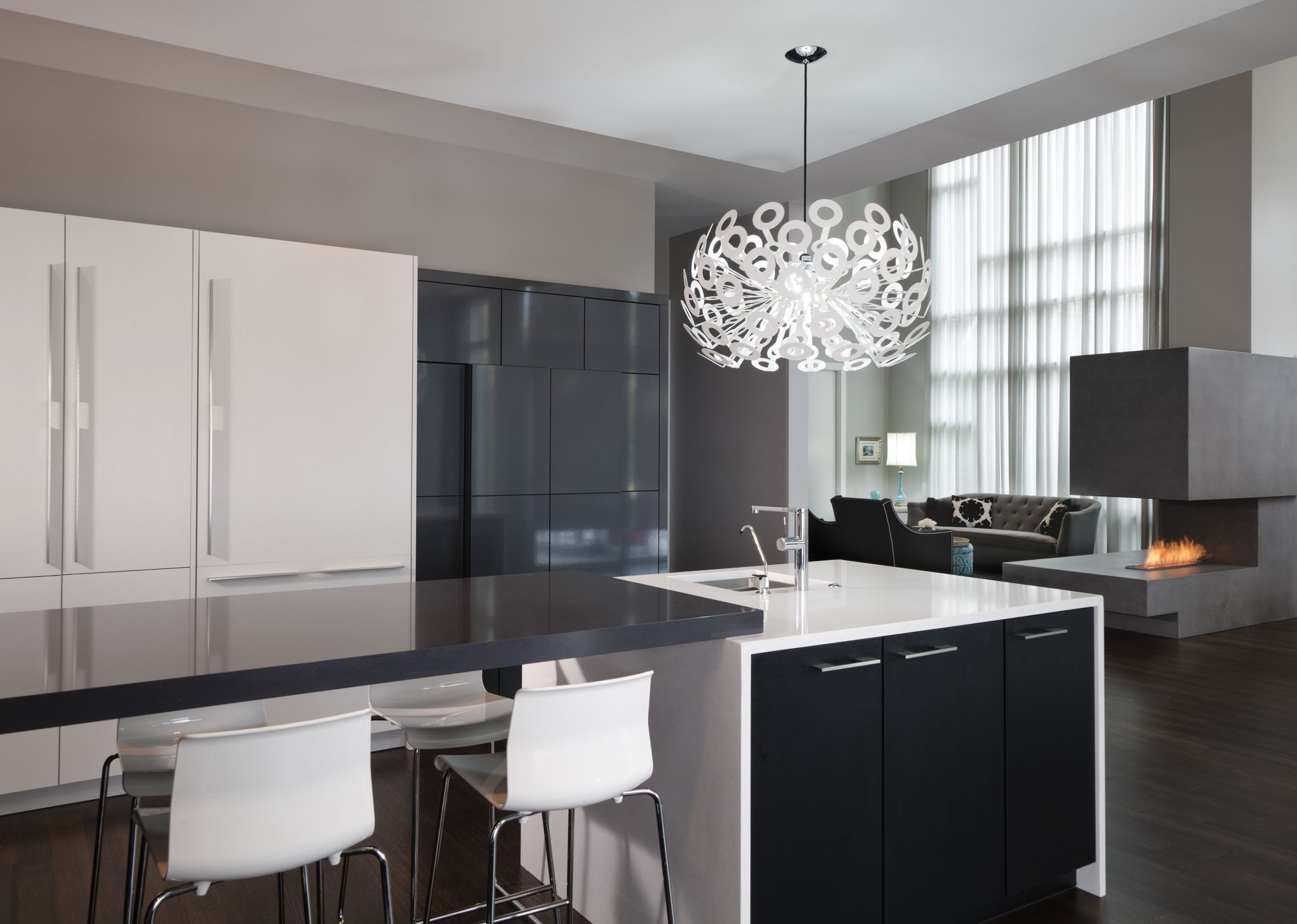 A kitchen with a large island and a chandelier hanging from the ceiling