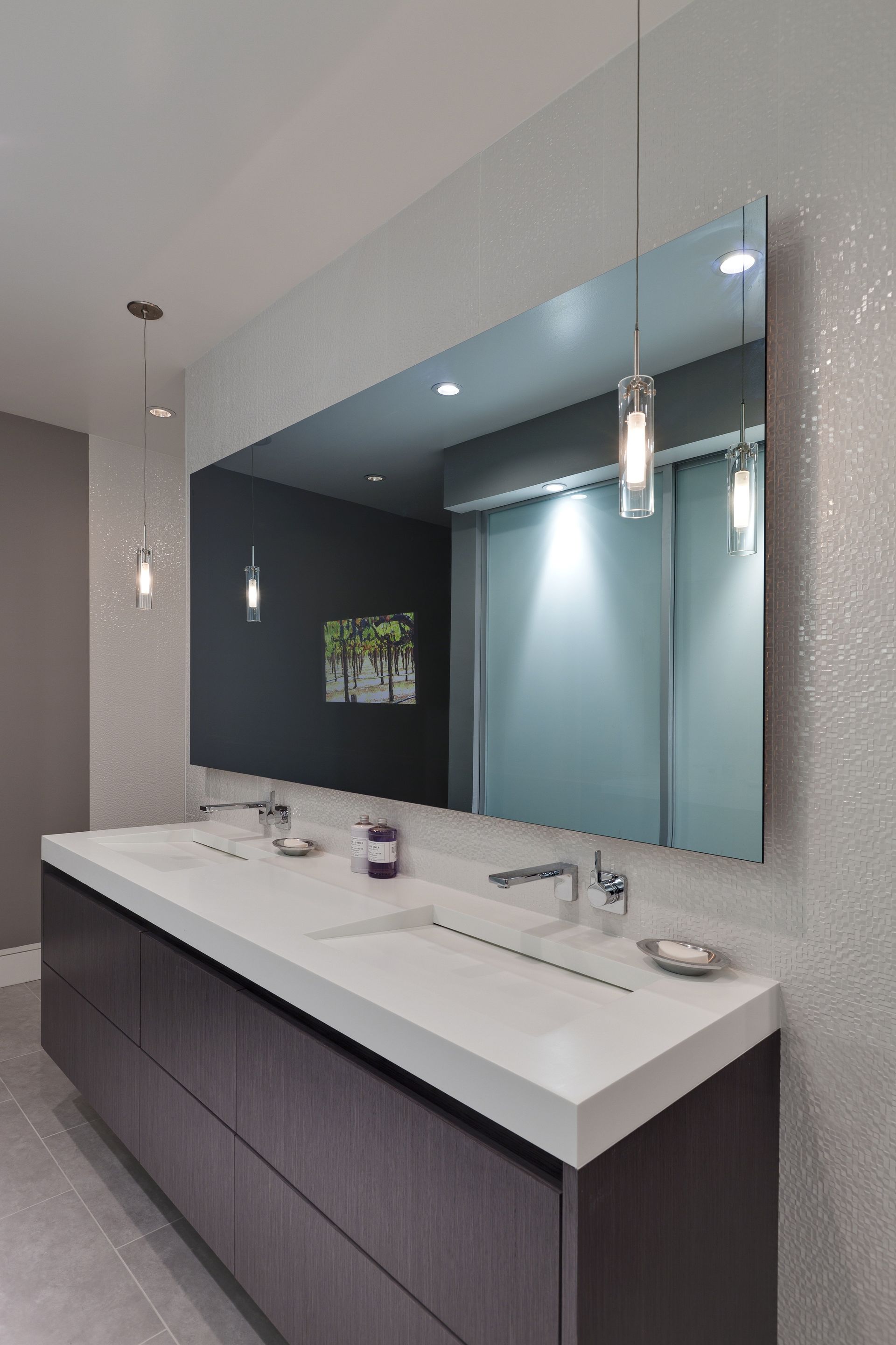 A bathroom with two sinks and a large mirror