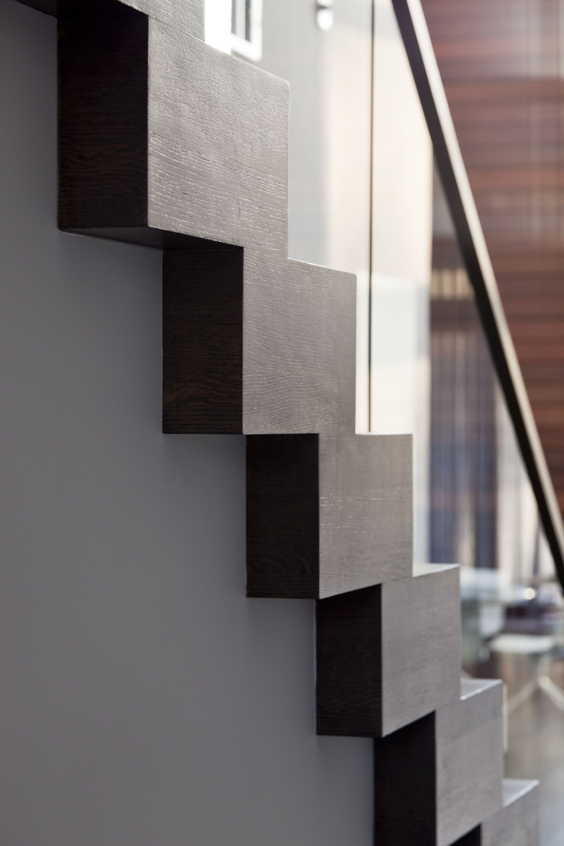 A close up of a staircase with a glass railing