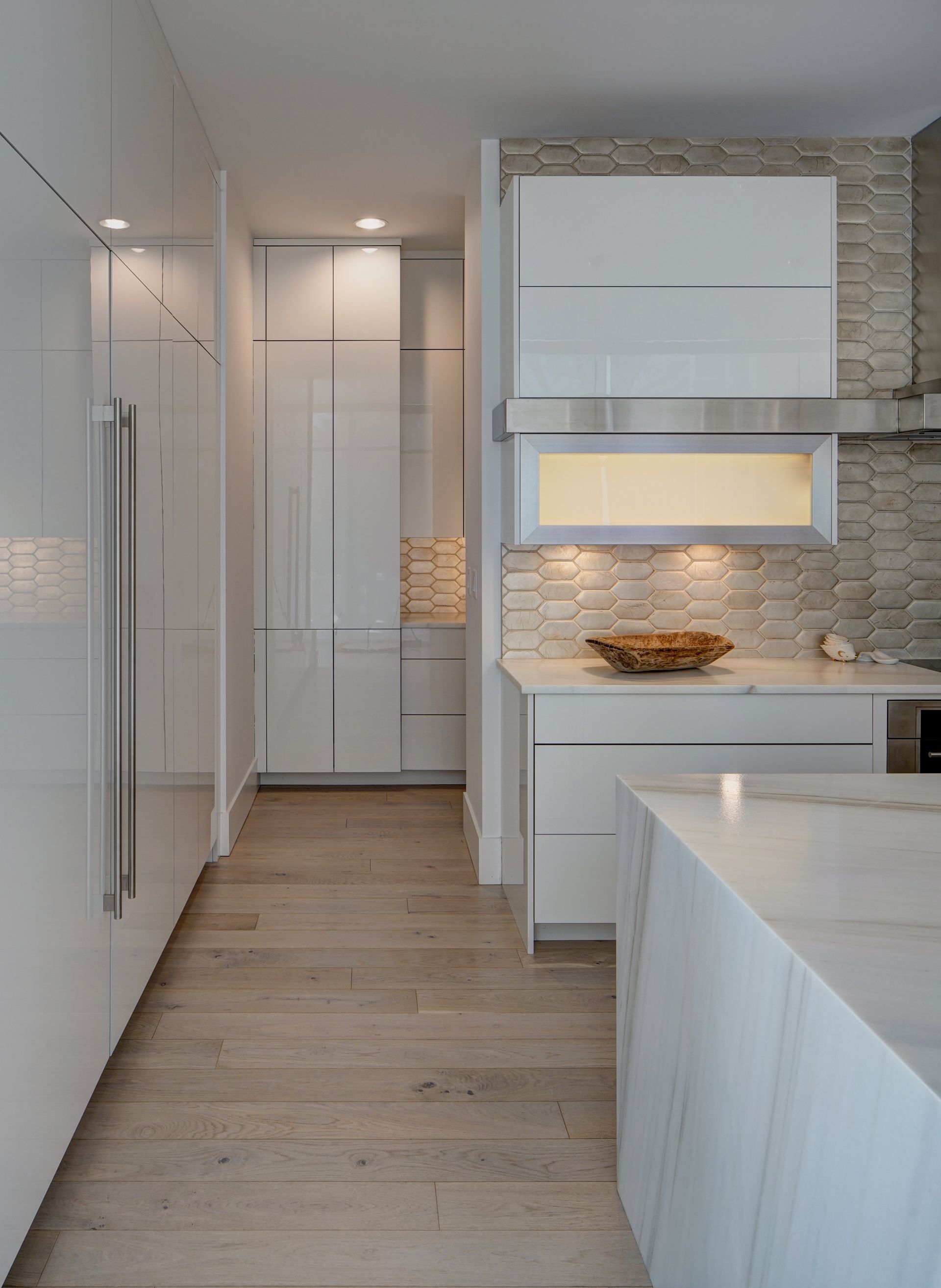 A kitchen with white cabinets and stainless steel appliances