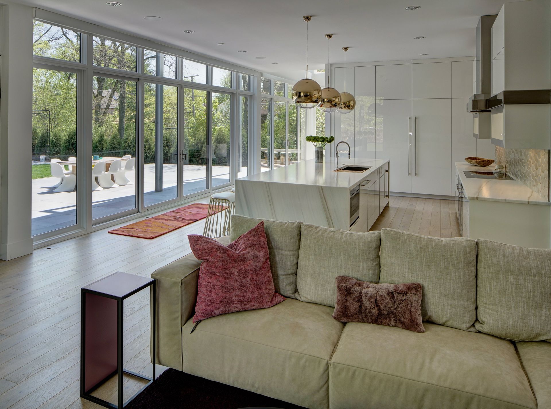 A living room with a couch and a kitchen in the background.