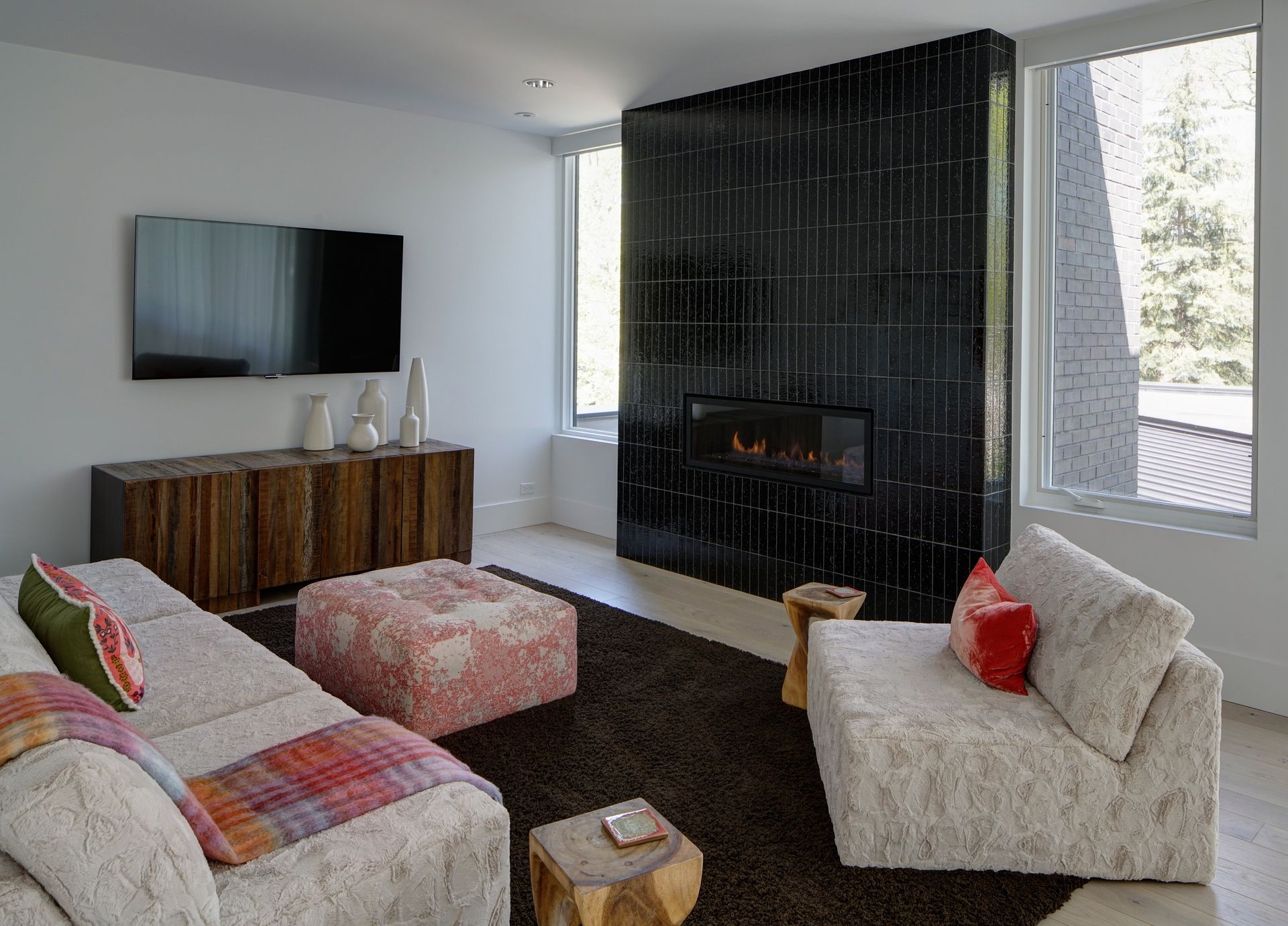 A living room with a fireplace and a flat screen tv