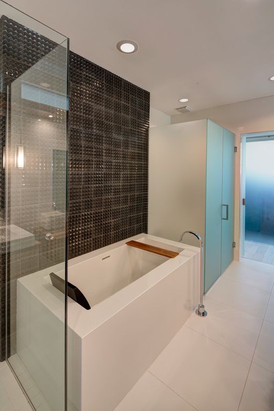 A bathroom with a bathtub and a walk in shower.