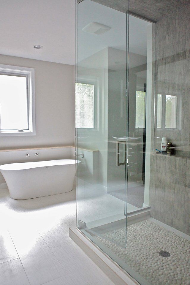 A bathroom with a bathtub and a walk in shower.