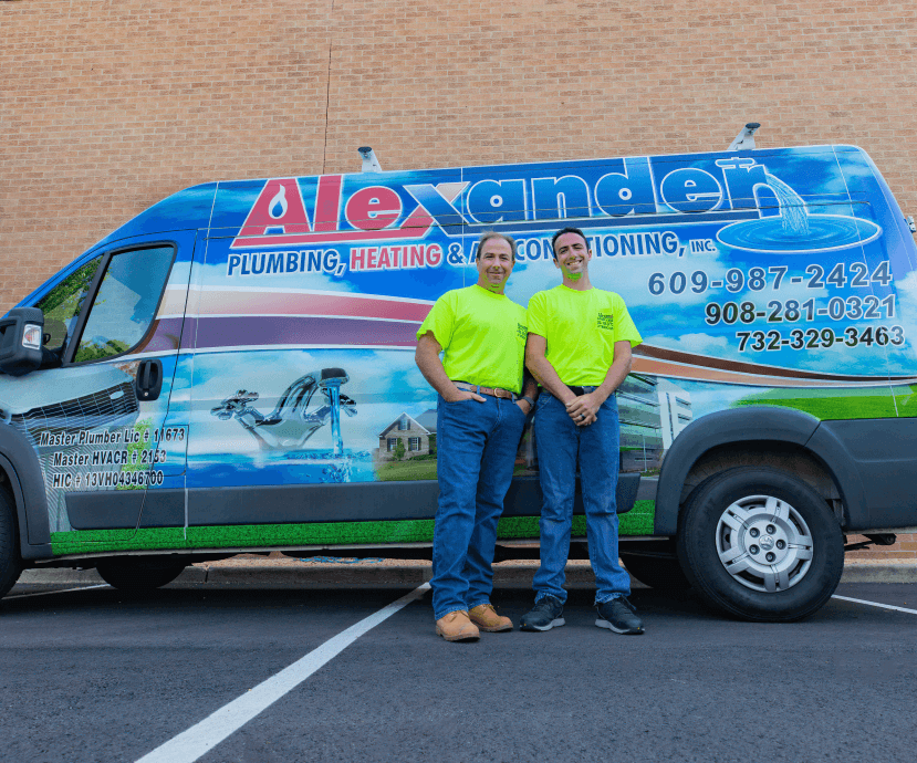 Technicians in front of an HVAC system services truck in New Brunswick, NJ