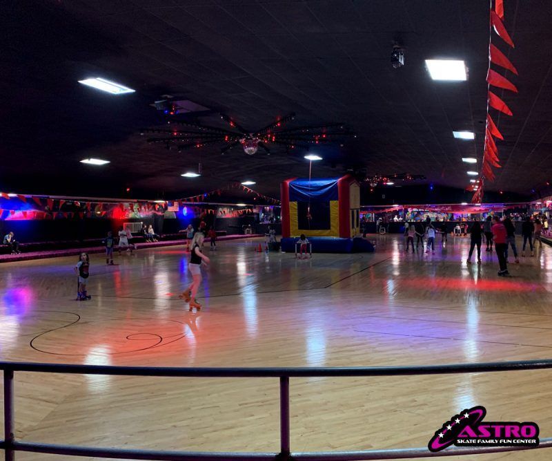 Large, old oak tree with white picket fence around the base, Spanish moss hanging from branches.