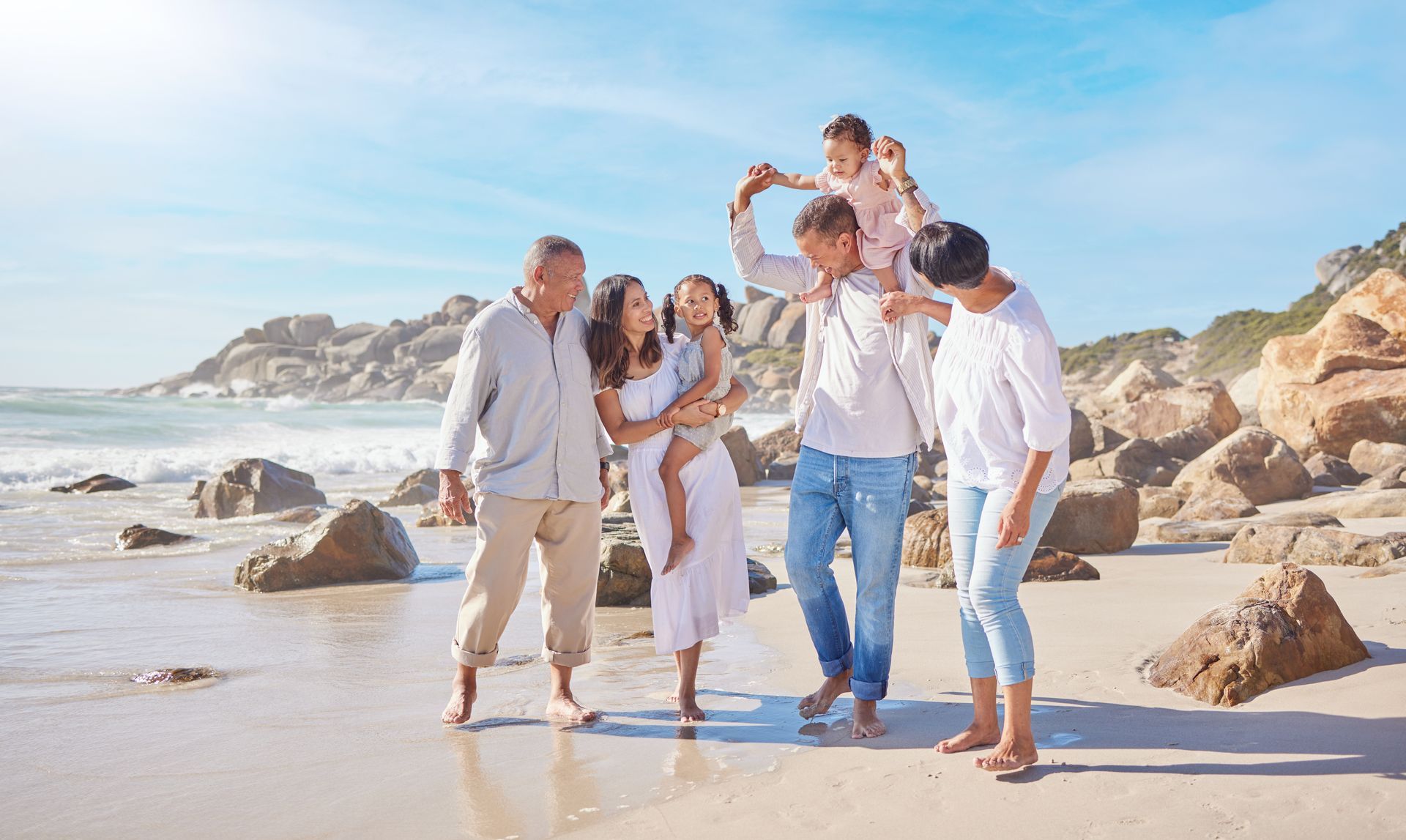 A family is walking on the beach.