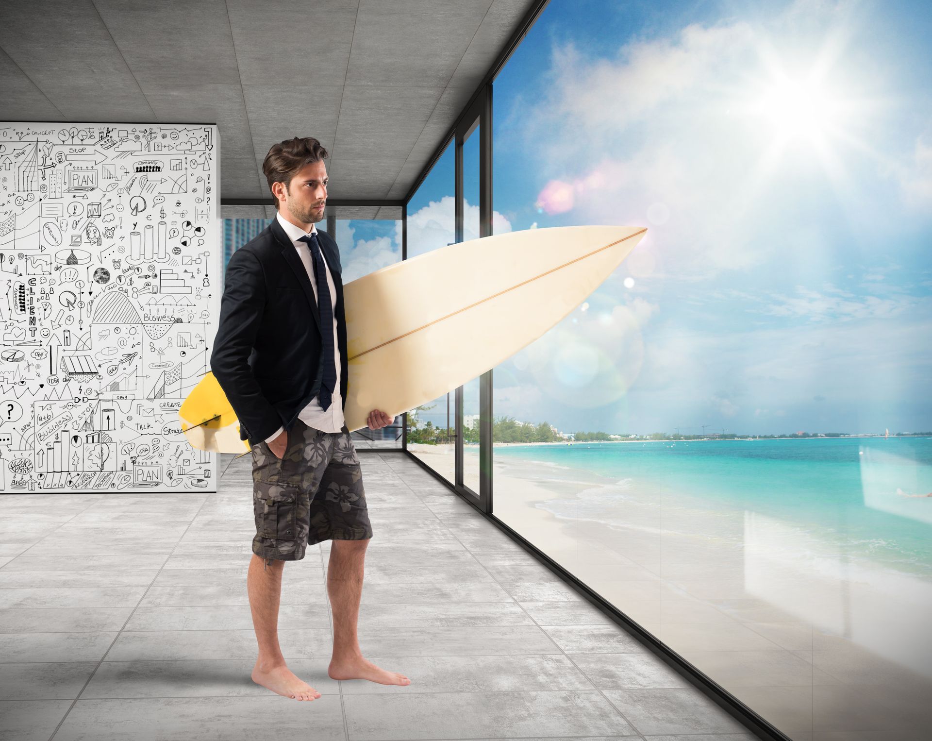 A man in a suit is holding a surfboard in front of a window.
