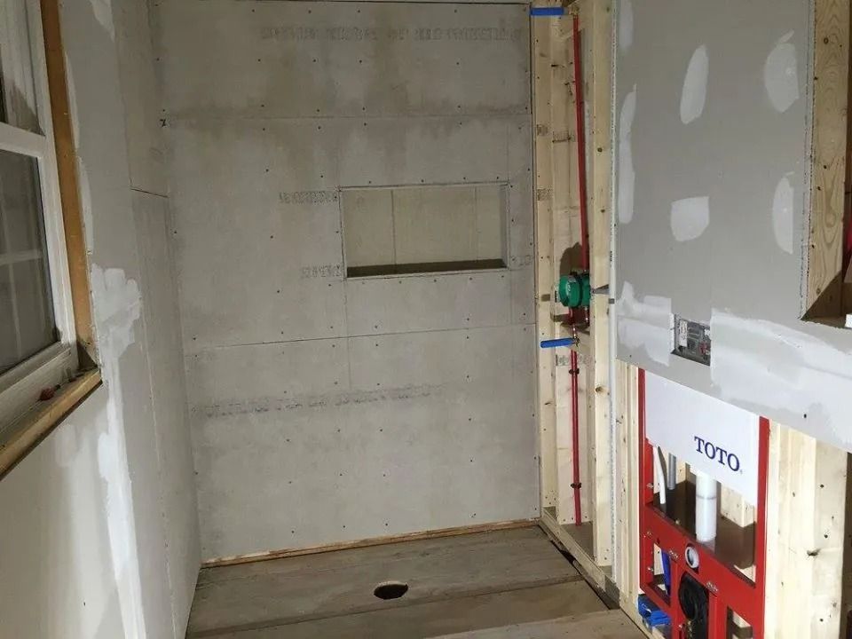 In-progress bathroom remodel with cement board shower walls.
