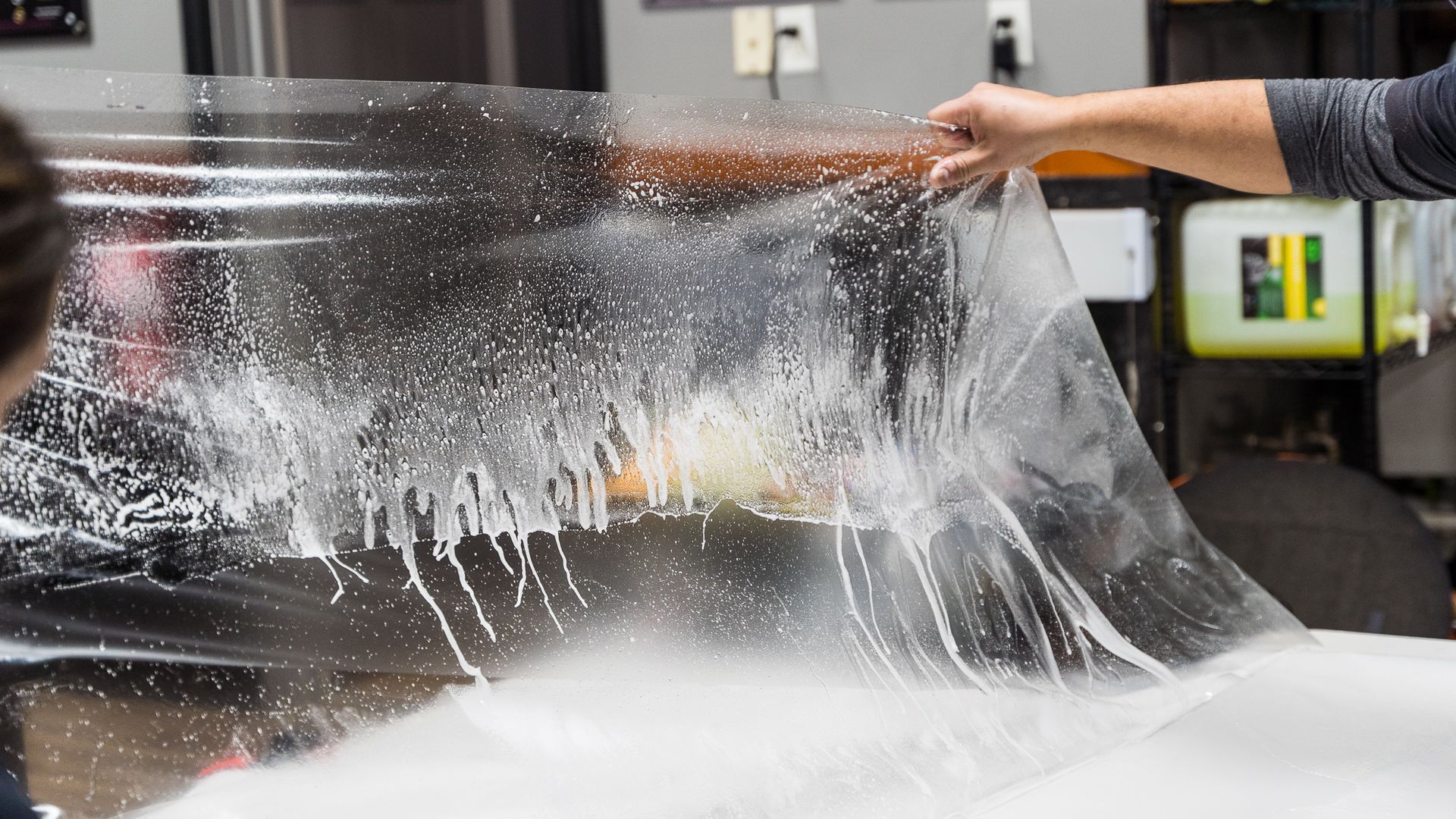 a person is cleaning the back seat of a car