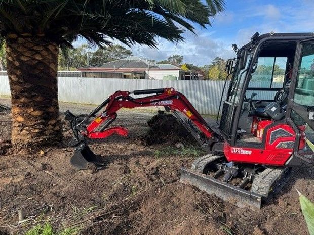 Excavator with bucket attachments and auger bits 