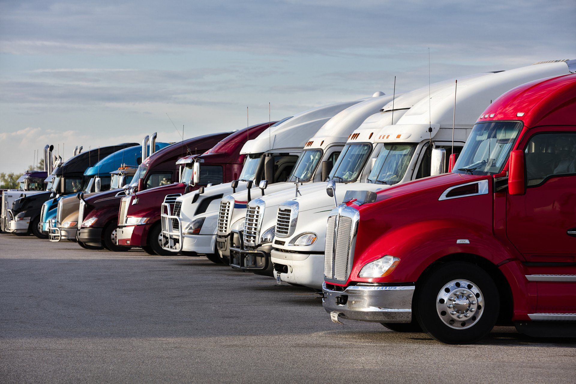 A row of trucks sitting a parking lot. 