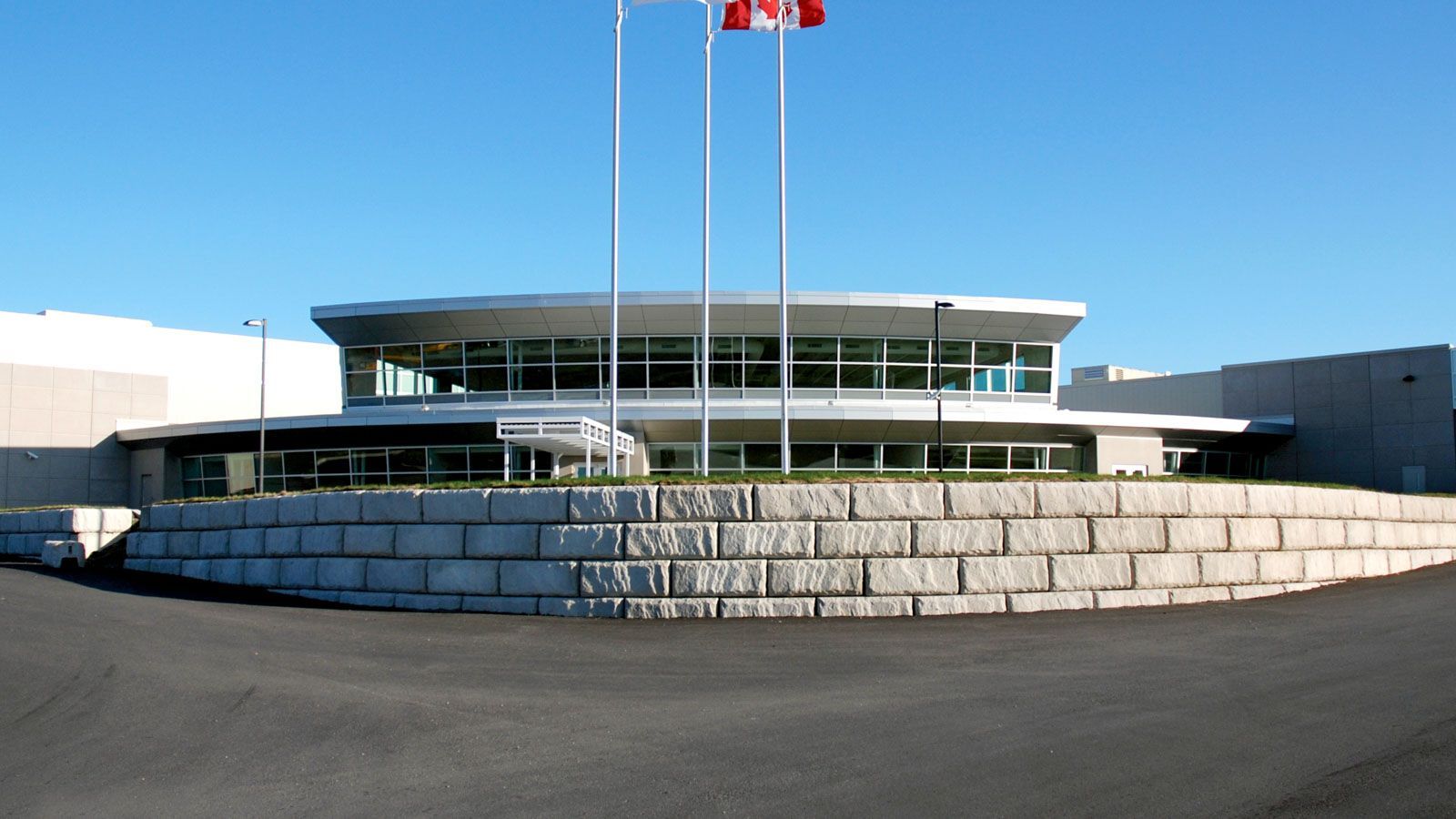 A large building with canadian flags in front of it