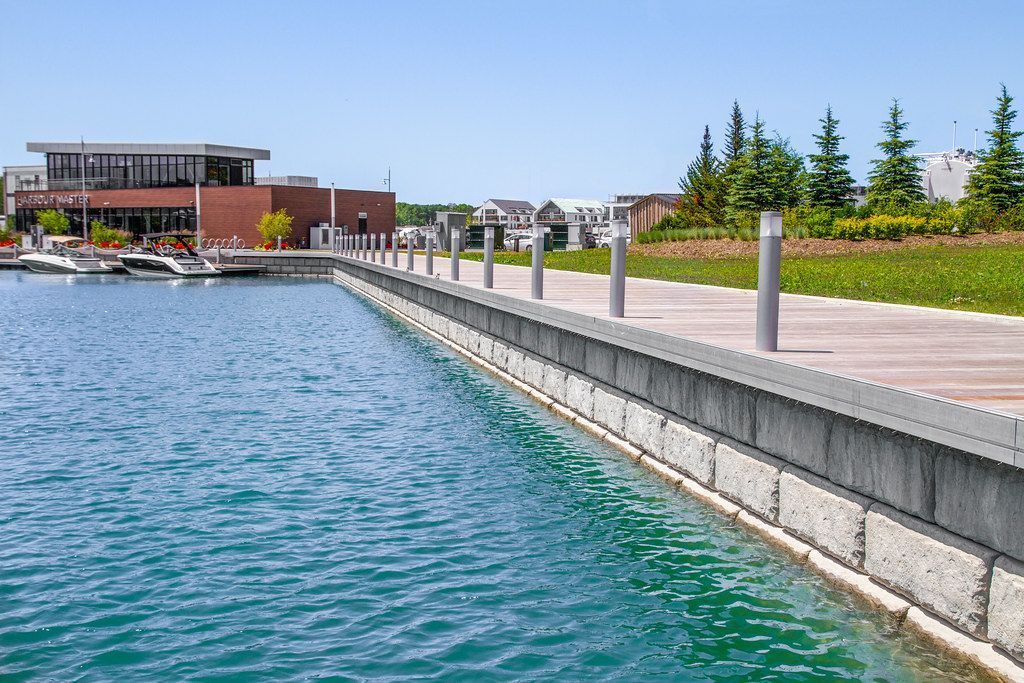 A large body of water with a dock and a building in the background.