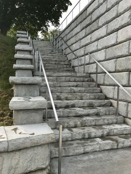 A set of stairs leading up to a brick wall