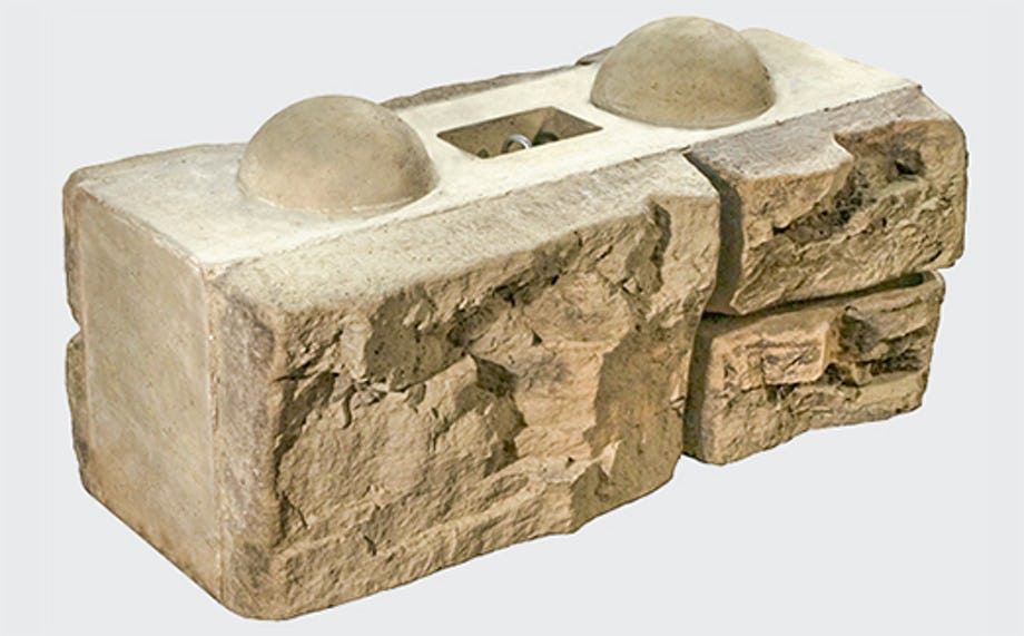 A close up of a stone block on a white background.