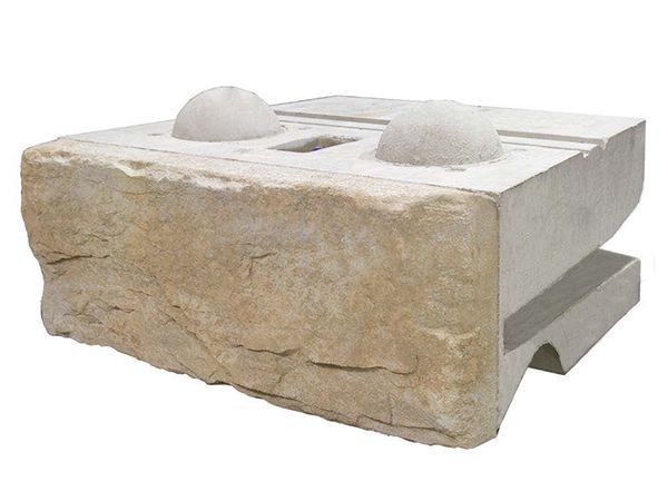 A concrete block with a hole in the middle on a white background.