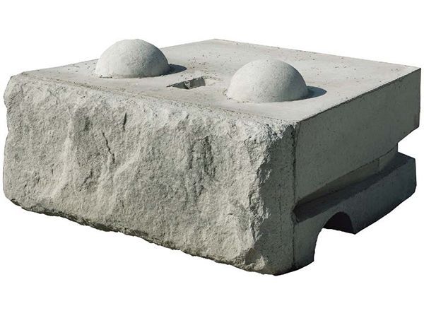 A concrete block with two balls on top of it