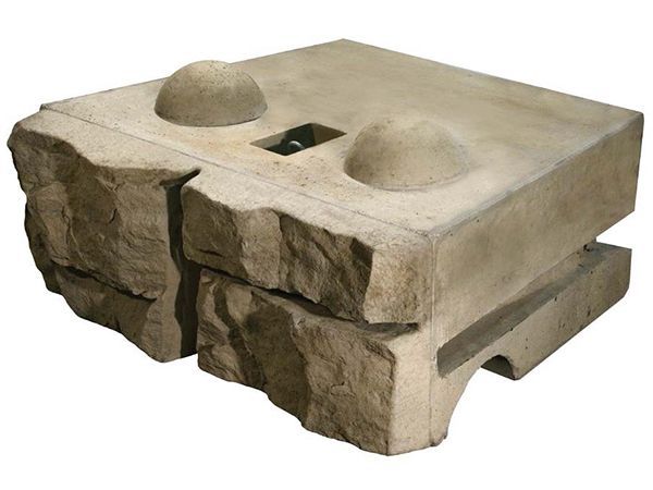 A piece of stone with two holes in it on a white background