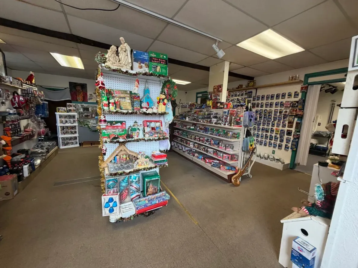 Interior shot of a retail shop, shelves displaying various items, including holiday-themed decorations.