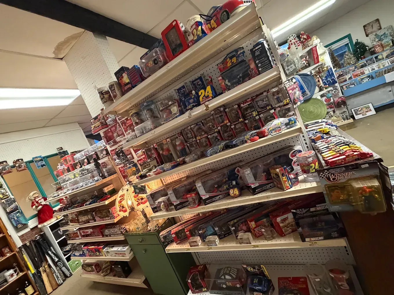Shelves of toys in a store. Many action figures and packaged toys are on display.