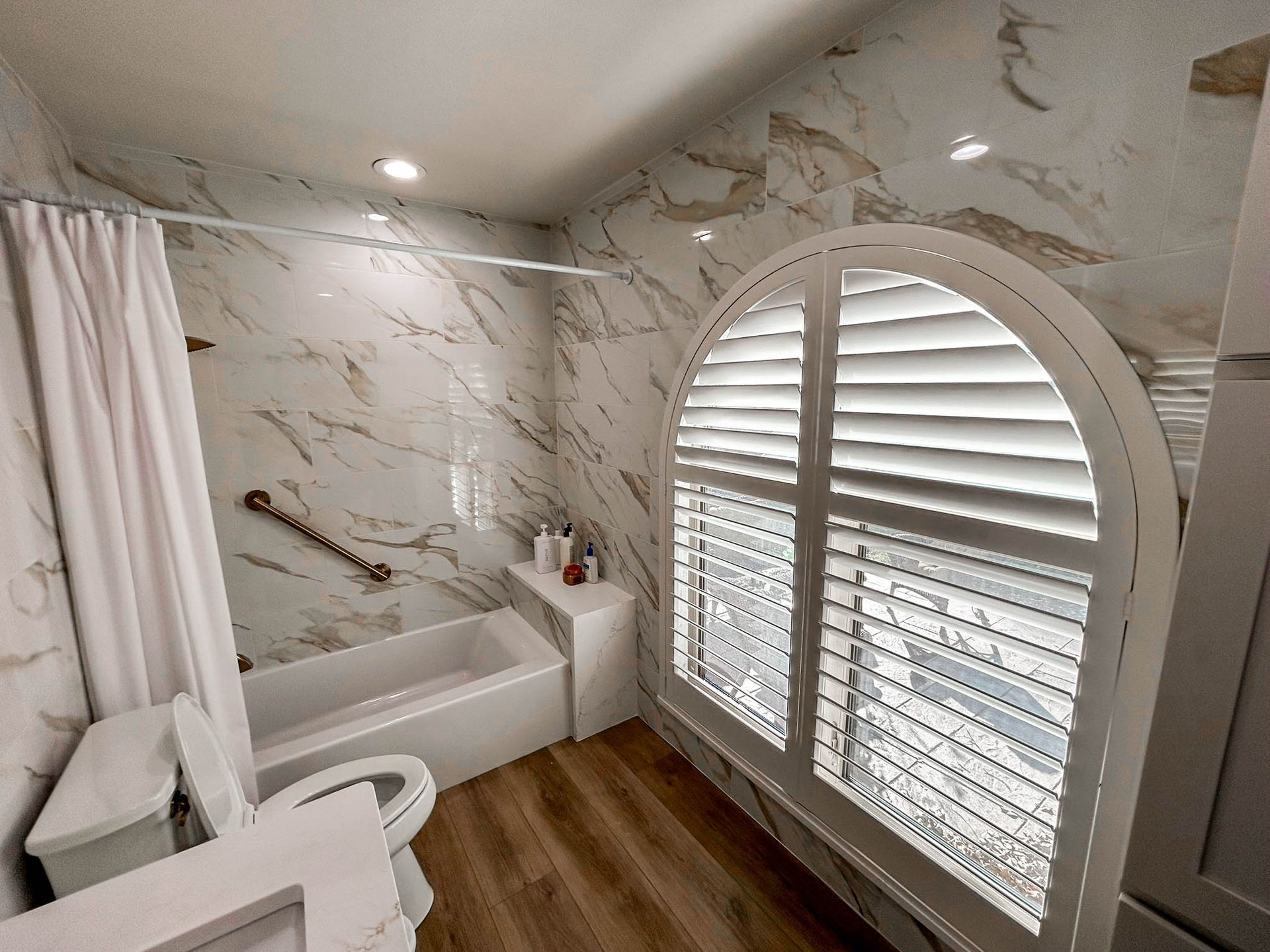 Plantation shutters installed in Irving, Texas bathroom by Love Is Blinds