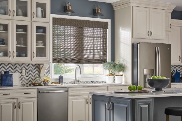 Love is Blinds TX: A kitchen with white cabinets and a stainless steel refrigerator, eco-friendly shades on window. 