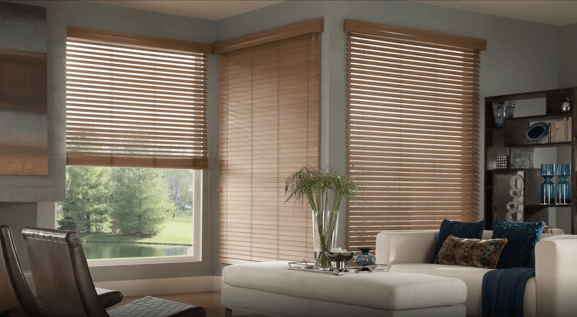 a living room with a couch , chairs , and blinds on the windows Classic look real wood blinds Georgia.