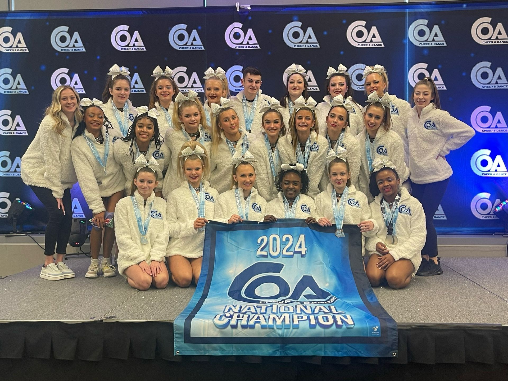 A group of cheerleaders holding a banner that says 1st place