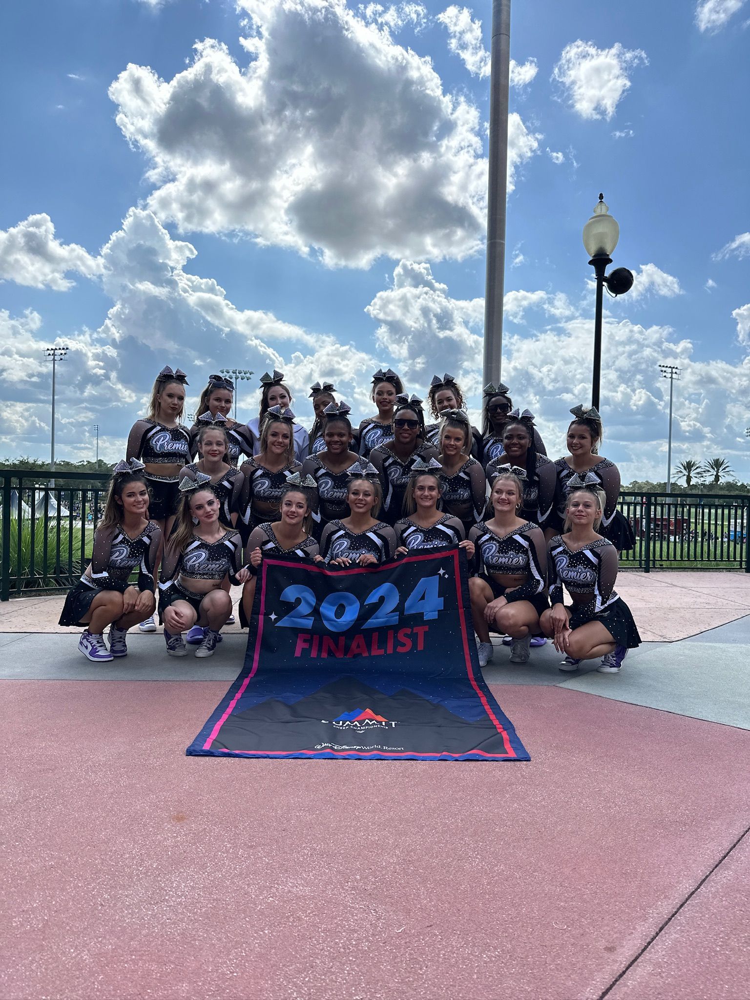 A group of cheerleaders are performing a stunt on stage