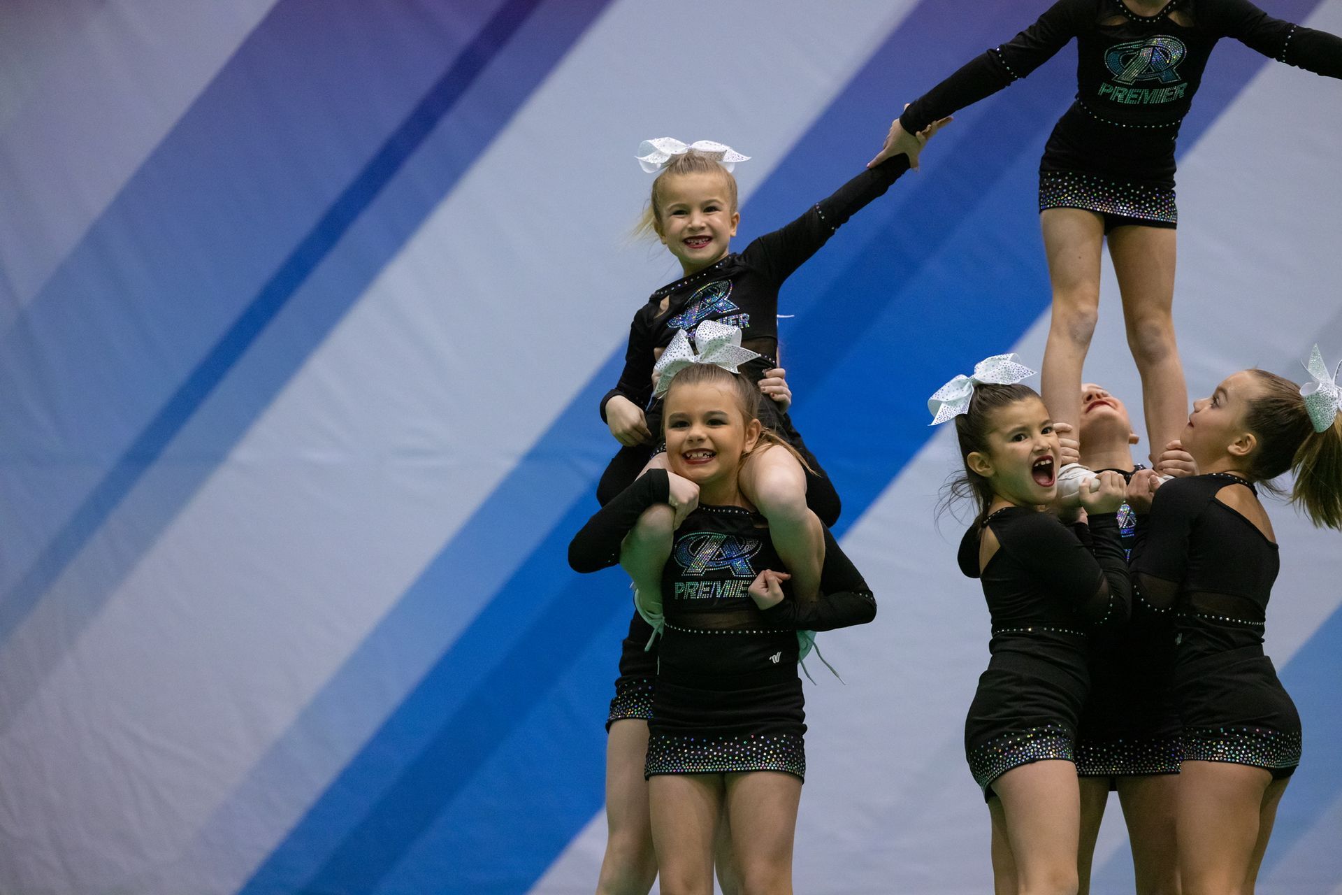A group of cheerleaders holding a banner that says 1st place