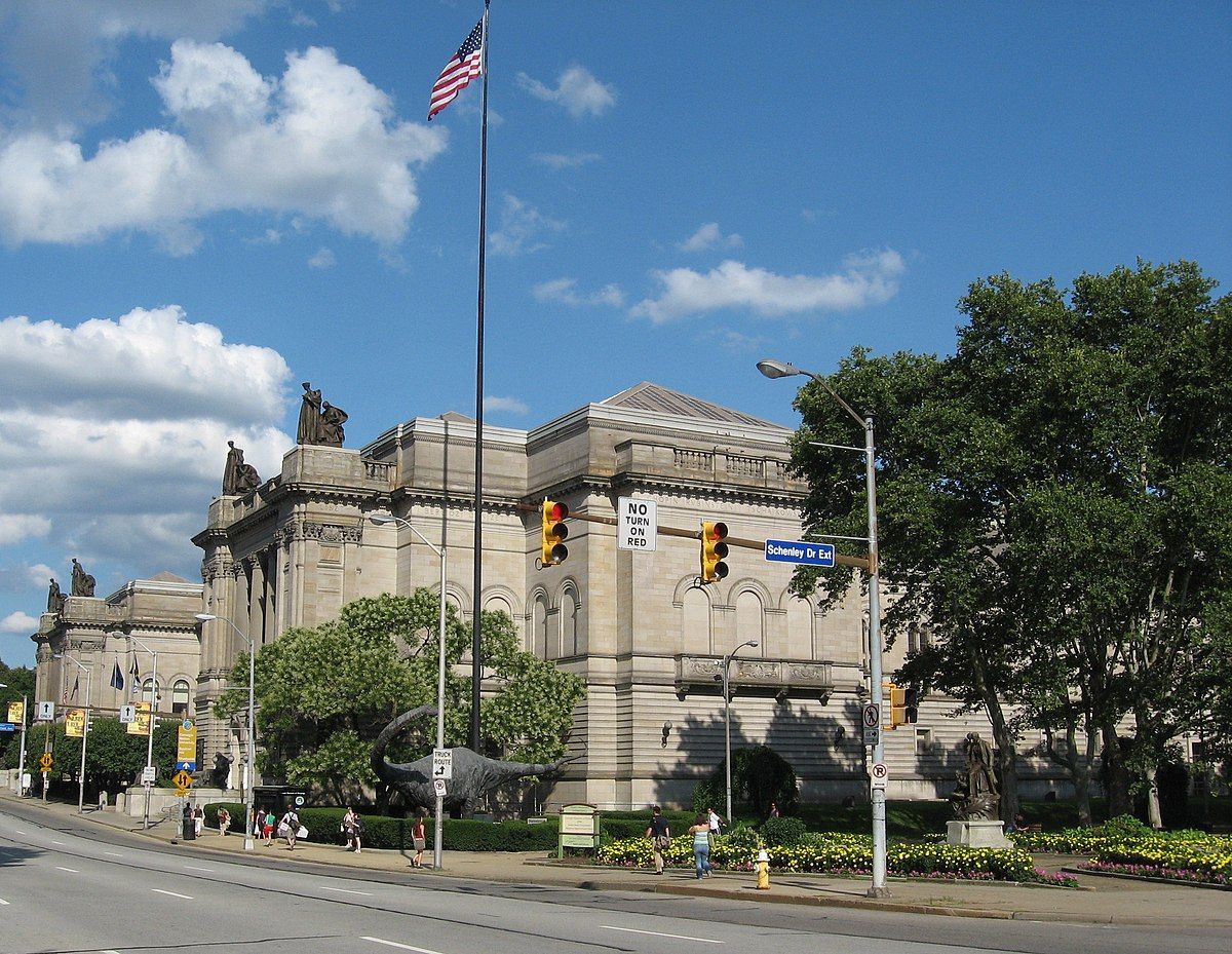 A large building with an american flag flying in front of it