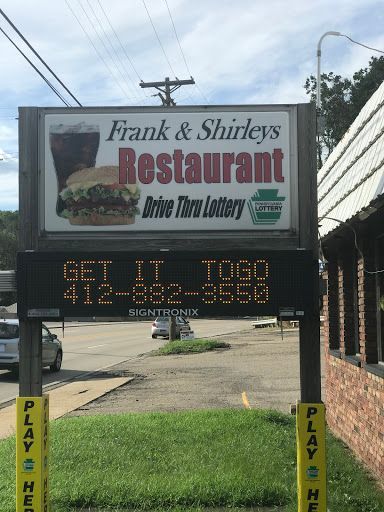 A sign for frank and shirley 's restaurant with a hamburger on it