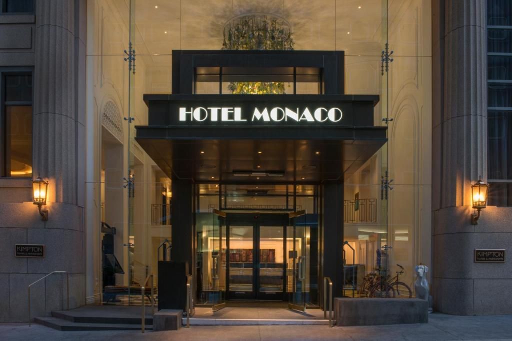 The entrance to the hotel monaco is lit up at night