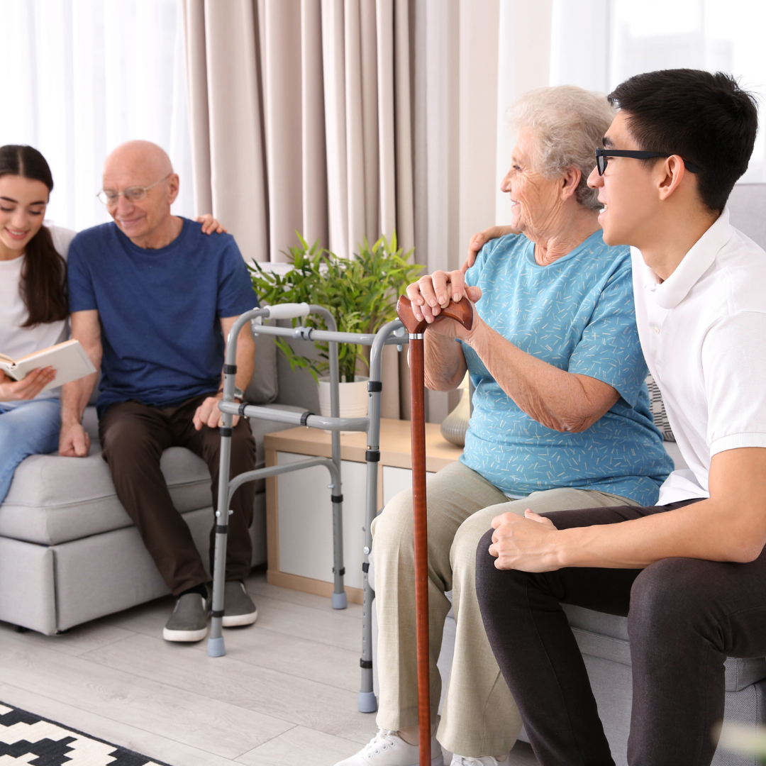 A group of people are sitting on a couch in a living room.