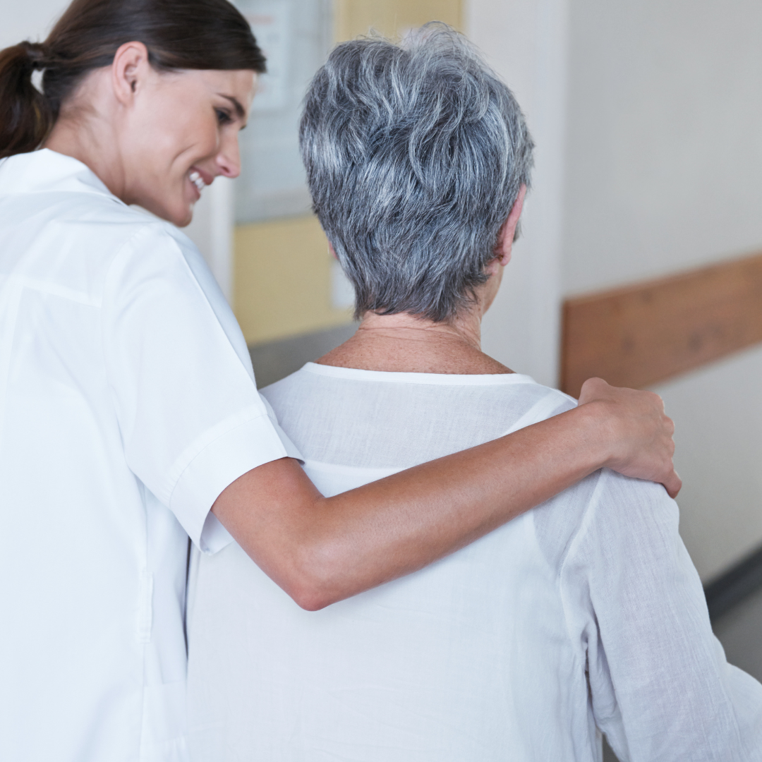 A nurse is helping an elderly woman walk