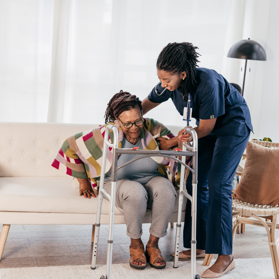 A nurse is helping an elderly woman use a walker.