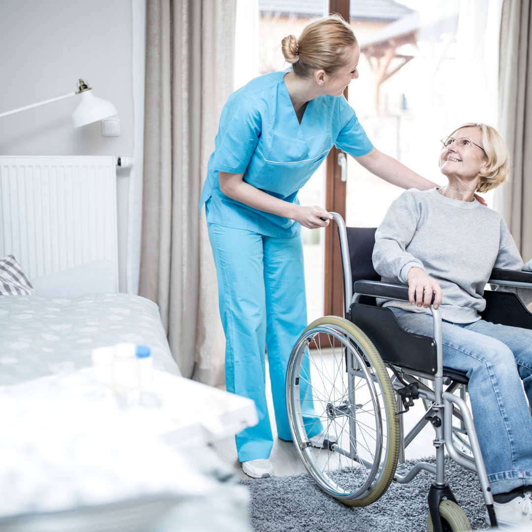 A nurse is helping an elderly woman in a wheelchair.